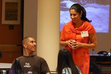 Robert Tostado, from San Diego State University, chats with Brittanya Murillo, a current MIT graduate student in the Department of Urban Studies and Planning, at the opening session of Converge 2005 at MIT. The weekend event is meant to introduce potential graduate students to MIT who may not have otherwise considered applying. <a onclick="MM_openBrWindow('converge-1-enlarged.html','','width=509, ...