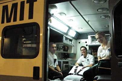 A new ambulance bay and ready room in the loading dock and basement of the Stata Center were dedicated Oct. 19. Nicolas Wyhs (S.B. 2005), left, and undergraduates Rachel Williams and William Baker are three of the students who run the service.
