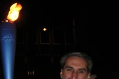 Daniel Nocera, MIT professor of chemistry, carries the Olympic torch through Rome on Dec. 8, 2005, the first day of its relay from Rome to the 2006 Olympics in Turin, Italy.