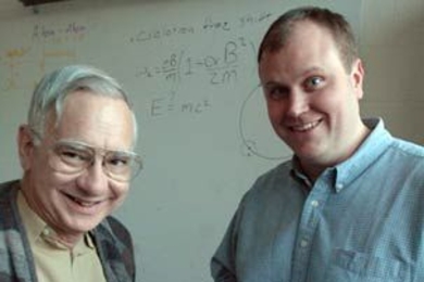 MIT physics Professor David E. Pritchard, left, and James K. Thompson display the key part of the apparatus they used to check Einstein's most famous equation. Their test was 55 times more accurate than previous tests.