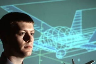 Carl Dietrich, 2006 winner of the $30,000 Lemelson-MIT Student Prize, holds a model of the personal air vehicle that he envisions for use in the air and on the road.