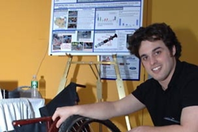Graduate student Amos Winter displays a wheelchair model currently being produced in Tanzania at a MacVicar Day exhibit March 3 in the Stata Center. Winter is working on technical solutions to the challenges faced by wheelchair users in that country.
