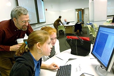 Professor of biology Graham Walker watches two Holliston High School students -- Hannah Cohen, left, and Kristen Mirageas -- explore the PDBViewer in the TEAL classroom in the basement of the Stata Center on Friday, March 31.