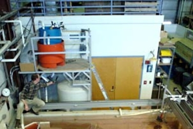 At MIT's Morphodynamics Laboratory, research scientist James Buttles adjusts the inflow valve of a sediment-laden, gravity-driven current flowing in an experimental channel. Observing how the sediment is deposited in and around the channel is providing new insights into the structure of oil-rich sediment-filled channels found deep under the sea floor.