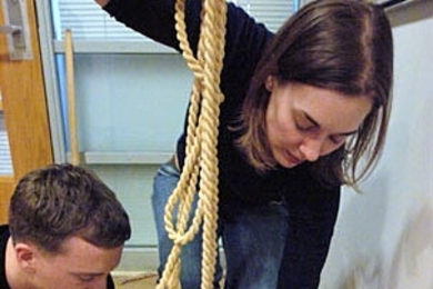 Sean Morton, a sophomore in materials science and engineering, and teaching assistant Elizabeth Cooney attach cords to create a replica of an Incan khipu.