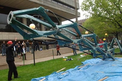The winning mini-skyscraper 'Muscles' is hoisted into position in front of the Student Center on Friday, May 12.
