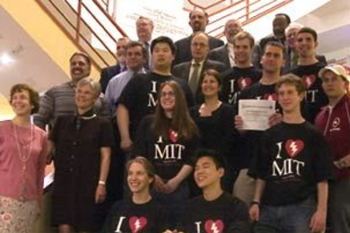 Community members display road signs that MIT received from the Metro Boston Emergency Medical Services Council on May 10. The signs, which will be installed on Massachusetts Avenue, reflect MIT's designation as the first HeartSafe college in the country.