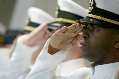 New MIT graduate and naval officer Piko A. Neal salutes the flag during the ROTC commissioning ceremony held Friday, June 9, at the U.S. Coast Guard Station in Boston.