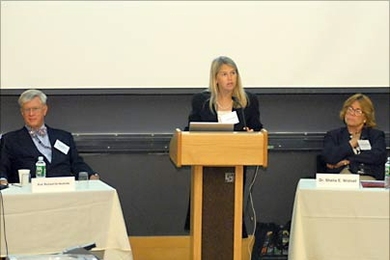 Professor Dava Newman, director of MIT's Technology and Policy
Program, makes introductory remarks at the program's 30th anniversary symposium, held June 8. TPP's founding director, Professor Richard de Neufville, and Institute Professor Sheila Widnall look on.