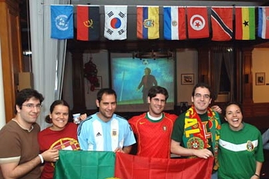 Soccer fans gather at Ashdown House for the World Cup first-round match between Portugal and Mexico held June 21. From left are Jorge Almeida and Clara Barata, both Harvard graduate students; new MIT graduate Reimundo Heluani; Marcus Dahlem, graduate student in EECS; Joao Castro, ESD graduate student; and Alejandra Menchaca, aero-astro graduate student. Menchaca was the only one in this group root...