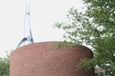 Graduate students on the 'Art on Wheels' tour stop outside the MIT Chapel on July 11. The chapel's spire and bell tower were designed by sculptor Theodore Roszak.