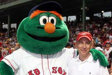 MIT Institute Professor Robert Langer poses with Red Sox mascot Wally the Green Monster before throwing out the ceremonial first pitch at Fenway Park on July 28.