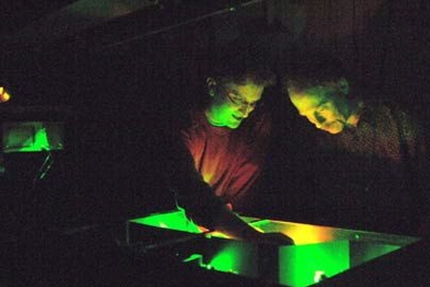 Peter Poulin, left, a former graduate student in the lab of Professor Keith Nelson, right, helps to set up a laser to observe light-induced changes in materials.