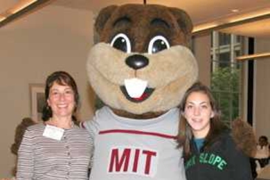 Tim the Beaver welcomes Carol McKenna, left, and her daughter, Claire, an MIT senior, during Family Weekend.