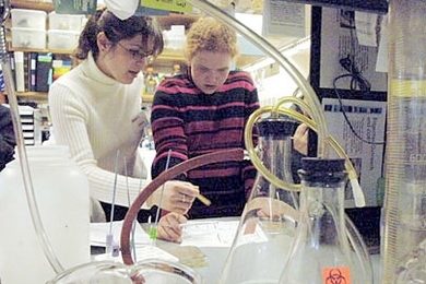 Postdoc Joanna Klapacz, left, works with Kennedy-Longfellow School sixth grader Ellie Montgomery in a genetics lab in the Edgerton Center program.