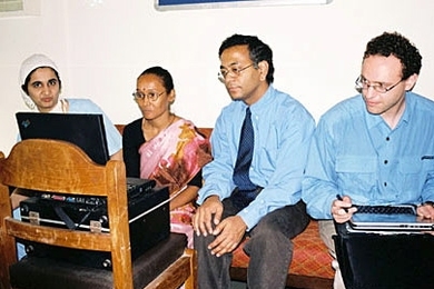 MIT researchers Pawan Sinha, center, and Yuri Ostrovsky, right, test the visual skills of a patient in India. The patient, known as S.R.D., had her vision restored at the age of 12.