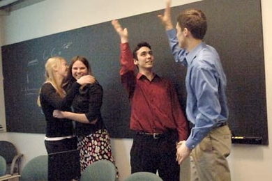 Biodiesel@MIT first-year students Katie Rowe, left, and Katrina Ellison embrace while junior Joe Roy-Mayhew, left, and senior Matt Zedler high-five. The group had just learned they had won the national Ecomagination Challenge for their initiative to turn used vegetable oil into biodiesel fuel for MIT campus vehicles.
