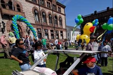 Harriette Crawford, left, Venola Bynoe, and Harriette's son Malik Crawford check out an intriguing vechicle in front of Cambridge City Hall.