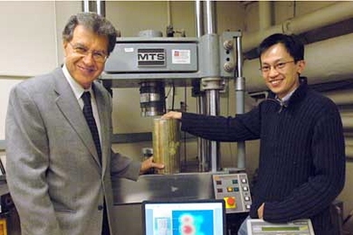 Professor Oral Buyukozturk of civil and environmental engineering, left, and student Tzu-Yang Yu in the lab with a concrete sample and an image (on the laptop screen) produced with the noninvasive damage-assessing technology they developed.