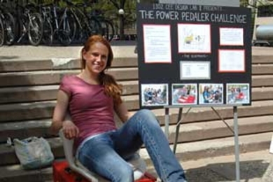 Civil and environmental engineering sophomore Liz Labuz powers the radio to her right by pedaling her team's "The Pedaler Challenge", a pedal machine that powers a radio. As a member of the CEE sophomore design course, she and her fellow classmates were required to design and built an energy-producing machine.