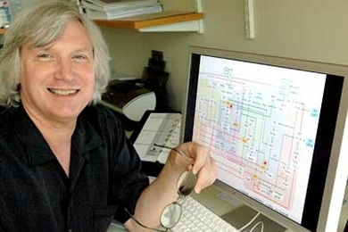 Douglas Lauffenburger, director of Biological Engineering, with a schematic of the intracellular "information-processing" circuit on the monitor in front of him.