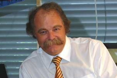 Professor Ian Hunter (standing), post-doc James Tangorra and colleagues in MIT's Bioinstrumentation Lab are working to create a robotic version of the bluegill sunfish's fin. Such a robotic fin, like the one Tangorra is holding, could improve the maneuverability of autonomous underwater vehicles.