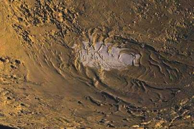 This image of Mars' south polar region shows the ice cap (in white) within the smooth polar layered deposits that overlie the cratered southern highlands.