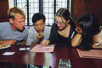 Left to right, freshmen Ian Tracy, Tung Shen Chew, Hannah Farrow and Melissa Diskin develop their strategy for conquering the fishing industry in the FishBanks game, part of a preorientation session last month.