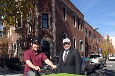 Ryan Flanagan, left, and vice president  Jerry Grochow of MIT's Information Services and Technology pose at the ready with the department's new 'green' cargo tricycle.