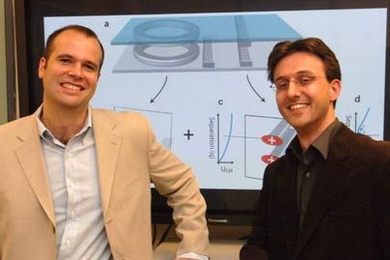 Postdocs Peter Rakich, left, and Milos Popovic of MIT's Research Laboratory of Electronics stand in front of a monitor that shows a demonstration of the way they propose to control microchips with light.