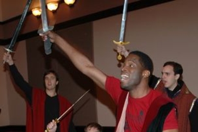 Taariq Lewis, in front, gives enthusiastic voice to Shakespeare's 'Henry V' along with, from left, Robin Lamb, Ben Frenkel and Ignacio Diaz. All are MIT Sloan students.