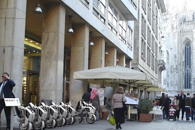 The low cost and foldable design of these electric scooters, as shown in this rendering outside the Duomo in Milan, could provide a convenient and efficient mode of transportation in urban environments.