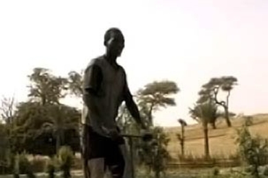 A Sudanese farmer operates a treadle-powered foot pump. Two MIT students have set up a company to sell the pumps to help subsistence farmers in the region.
