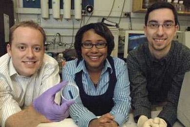 From left, Broad Institute postdoctoral associate Kris Wood, Bayer Professor of Chemical Engineering Paula Hammond and chemical engineering graduate student Dan Schmidt show the thin film they have developed. The film releases drugs and other chemical agents upon application of a small electrical field.