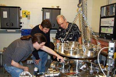 Graduate students Dan Casey and Mario Manuel, left, and senior research scientist Richard Petrasso of the MIT Plasma Science and Fusion Center with the detector used to study implosions that recreate the high temperatures and densities found inside stars.