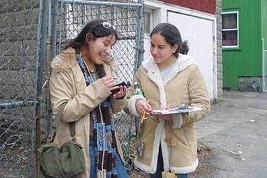 MIT was recently named to the President's Higher Education Community Service Honor Roll for exemplary service efforts and service to disadvantaged youth for the success of its MIT@Lawrence project. This photo, taken in 2004, shows MIT student Claudia Canepa and Lawrence resident Rebecca Camargo as they map properties in the city's North Common neighborhood.