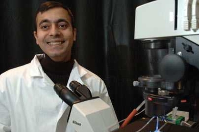 Professor Rohit Karnik works in the lab with the new method for cell separation that he, Institute Professor Robert Langer and other colleagues have developed. It involves steering rolling cells and could lead to devices for rapidly detecting diseases.