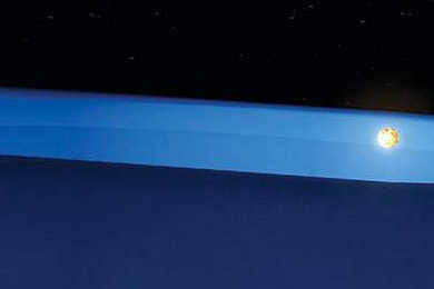 The unusual geometry of this star system made it possible for researchers to discover the first evidence of the middle stages of planet formation. Above, one star rises above the obscuring disk of matter, and its light becomes visible.