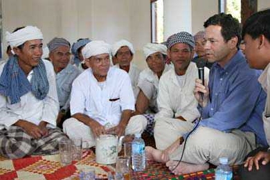 Adjunct Professor of the Humanities in the Program in Writing Alan Lightman sits in the mosque built by his and his wife's Harpswell Foundation with villagers, Muslim Chams (of the San Cham sect).