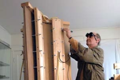 MIT biology research affiliate Joe Davis works in his apartment in Cambridge on the prototype for a Hurricane Katrina memorial--a 109-foot tower that will send laser beams into the sky. He recently won a Rockefeller fellowship for the project.