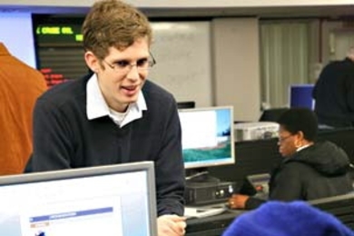 MIT undergraduate Randy Shults, top left, a coordinator for the volunteer organization Families Accessing Computer Technology, works with one of the program's clients, Nicole Doctor, bottom.