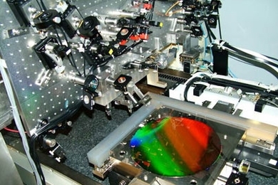 Gratings used to manipulate X-rays for future space telescopes and other applications, like tiny miniaturized venetian blinds, were created using this interference lithography patterning tool, called the nanoruler, developed at MIT's Space Nanotechnology Laboratory. The colorful, diffracting wafer at center has a diameter of 12 inches.