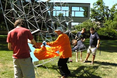 Matt Ritter, Doug Wood, Spencer Ahrens and Micah Sze mount one of the 10-inch by 12-foot mirror panels in place.