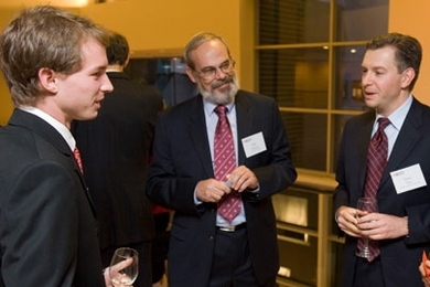 MIT Professor Eric Grimson, center, and alumnus Jake Seid, right, talk with Scot Frank, a senior in EECS who has gone on several MISTI internships, during the MISTI 25th anniversary celebration.