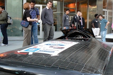 Visitors to Energy Night at the MIT Museum examine the Solar Electric Vehicle Club's original car, which will soon be replaced by a newer version.