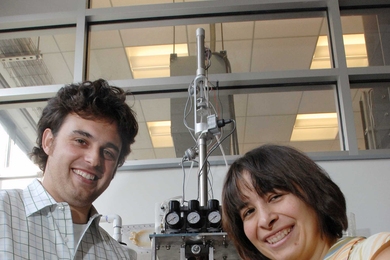 Mechanical Engineering Professor Anette Hosoi and graduate student Amos Winter developed a robo-clam that could lead to "smart" anchoring technologies. Outside the testing device they hold clamshells of some of the clams they tested.