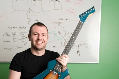 Media Lab student Amit Zoran shows the Chameleon Guitar, along with a variety of the interchangeable soundboards -- made of different woods and other materials -- that can be inserted to alter the guitar's acoustic characteristics.