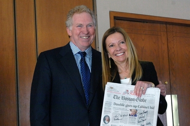 Phillip (Terry) and Susan Ragon hold a copy of The Boston Globe issue that announced the creation of the Phillip T. and Susan M. Ragon Institute. All the principals -- the Ragons as well as the leaders of MGH, MIT and Harvard -- signed the newspaper.