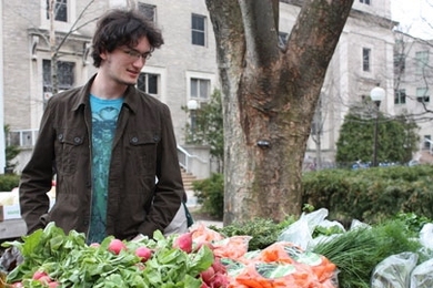 Josh Bails, a sophomore in the Department of Brain and Cognitive Sciences, checks out East Campus' new produce stand during its first day of operation on March 31.