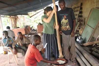 Ela Ben-Ur '97, SM '99, one of the International Development Design Summit organizers, pounds a mixture of plants to make a porridge called fufu, a local staple food, at a small farm in Ghana.